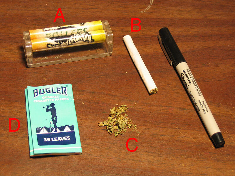 Spliff rolling supplies — papers, rolling machine, and cannabis